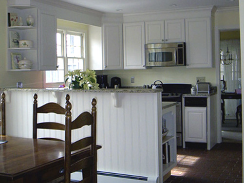 A kitchen well suited for cooking and storage plus a divider for the breakfast area